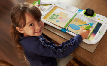 Little girl playing on the LeapFrog LeapStart