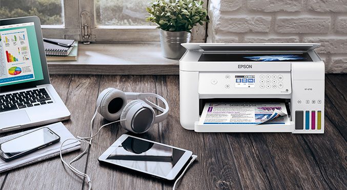 Printer on desk with headphones and notepad