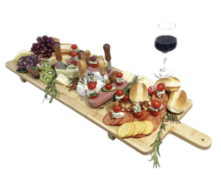 Charcuterie board filled with meat, cheese, fruit