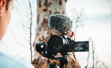 A man is filming himself with a camera mounted on a gimbal