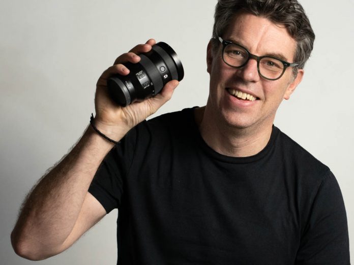 A photo of photographer Justin Morrison holding the Sony FE 24-105mm G OSS lens