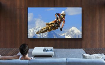 image of a woman on a sofa watching a mountain biker on smart TV