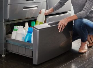Image of a woman opening a pedestal drawer beneath a washing machine to store cleaning supplies