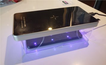 image of the UV sterilizer box placed over a phone and shining UV light on it