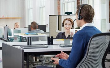 Office workers conducting a conference call with a logitech webcam