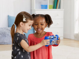 Two kids playing with a VTech Kidizoom camera