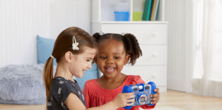 Two kids playing with a VTech Kidizoom camera