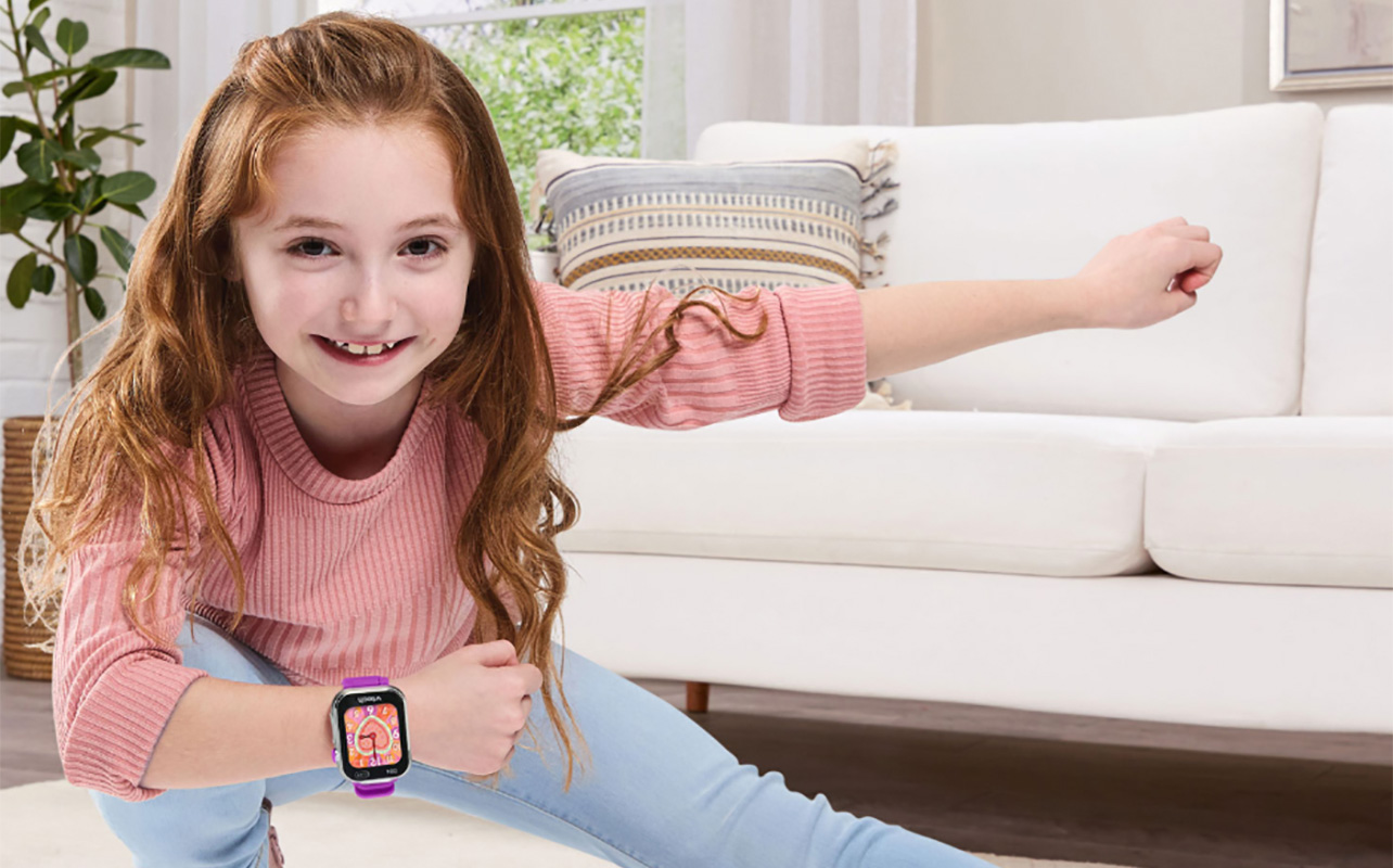 A girl posing while wearing the VTech Kidizoom smartwatch