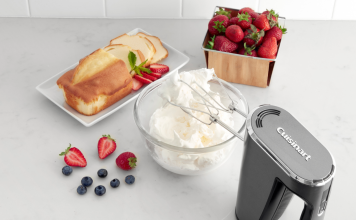 Image of the Cuisinart Cordless Hand Mixer mixing a bowl of cream with fruit and cake nearby