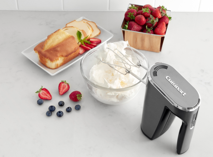 Image of the Cuisinart Cordless Hand Mixer mixing a bowl of cream with fruit and cake nearby