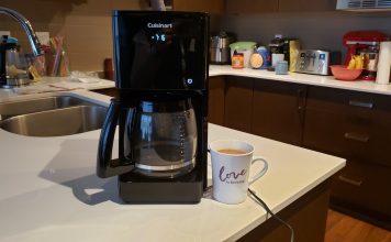 image of the coffee maker next to a mug of coffee