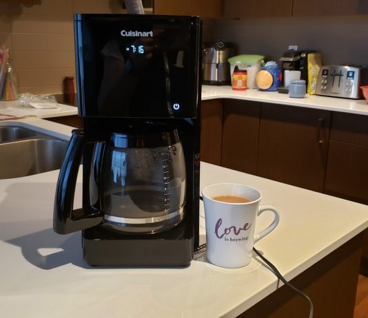 image of the coffee maker next to a mug of coffee