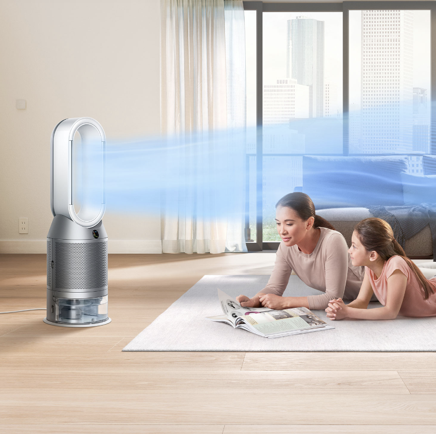 Mom and daughter on the floor with a Dyson air purifier.