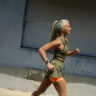 A woman running while wearing the Google Pixel Watch 3.