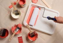 A paint tray with roller and paint.