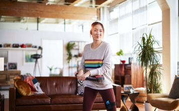 A young woman playing Ring Fit Adventure