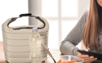 Girl having lunch while on her phone.