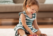 Little girl playing with sensory toys.