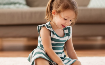 Little girl playing with sensory toys.