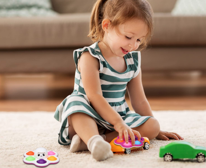 Little girl playing with sensory toys.