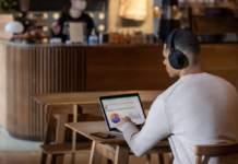 Man wearing headphones while studying in cafe