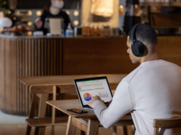 Man wearing headphones while studying in cafe