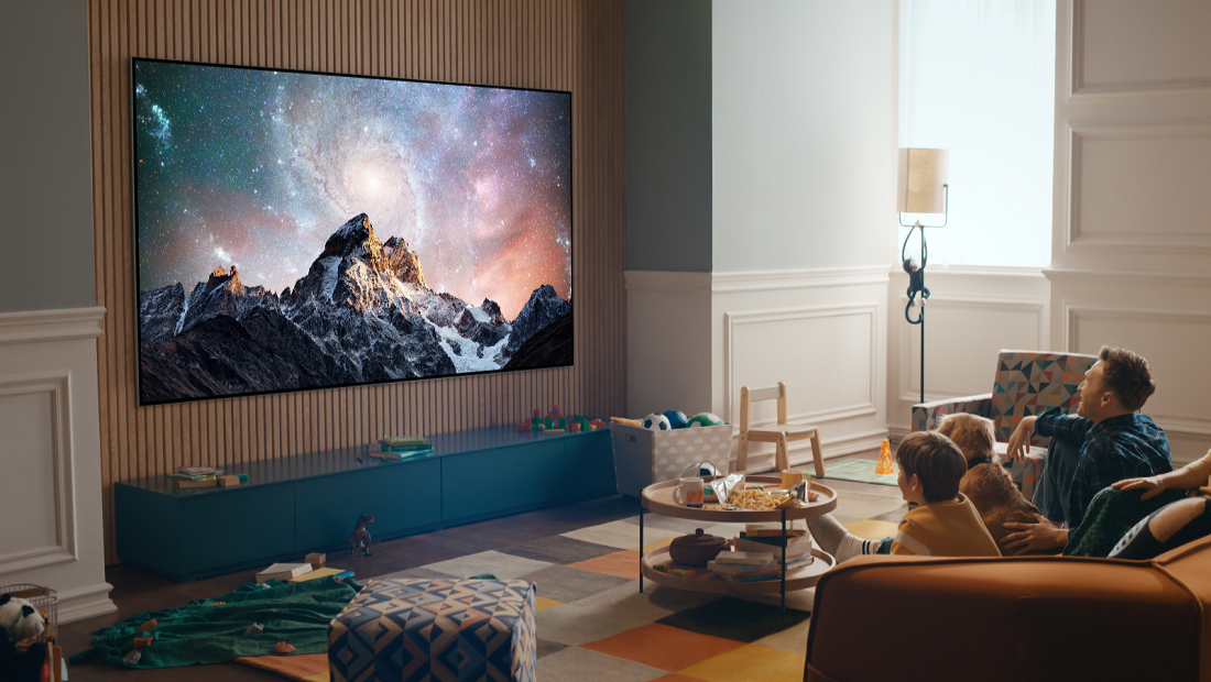Family watching on an OLED Smart TV in a bright open living room