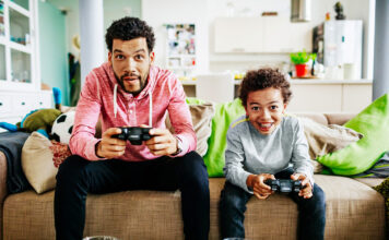 Dad with son playing a video game.