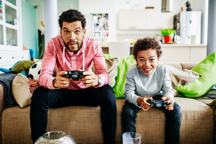 Dad with son playing a video game.