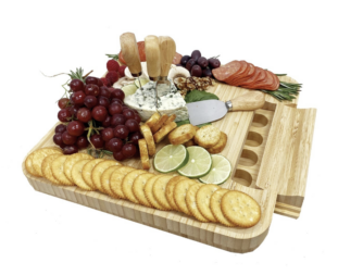 cheese, crackers, and fruit on a cheeseboard