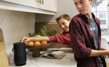 Two teens in the kitchen with the Bose portable smart speaker