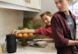 Two teens in the kitchen with the Bose portable smart speaker