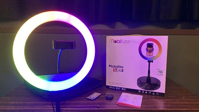 Fully set up Mobifoto ring light showcasing it's range of colors next to it and the box