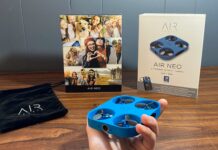 Airselfie AIR NEO Camera drone and Power Bank Bundle being held with the box in the background next to the carrying bag
