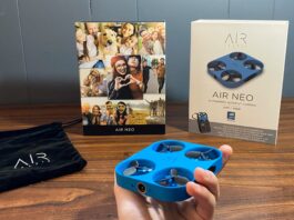 Airselfie AIR NEO Camera drone and Power Bank Bundle being held with the box in the background next to the carrying bag