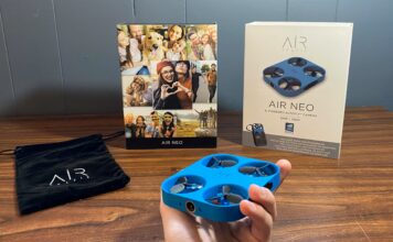 Airselfie AIR NEO Camera drone and Power Bank Bundle being held with the box in the background next to the carrying bag