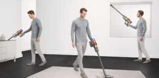 A man vacuuming three different areas of a home with a Dyson cordless vacuum.