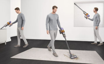 A man vacuuming three different areas of a home with a Dyson cordless vacuum.