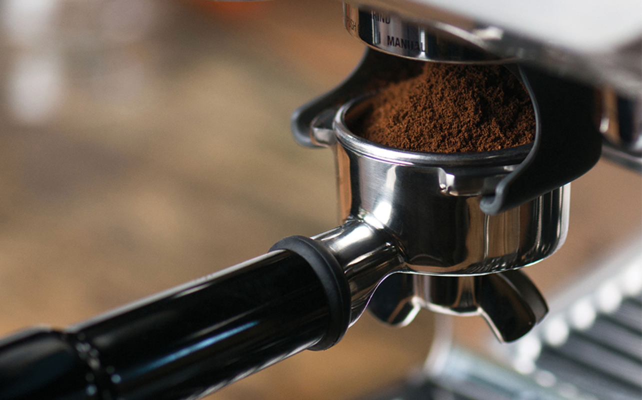 Ground coffee beans in espresso machine.