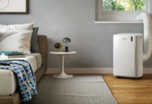 De'Longhi Pinguino portable air conditioner keeps a bedroom cool.