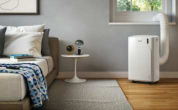 De'Longhi Pinguino portable air conditioner keeps a bedroom cool.