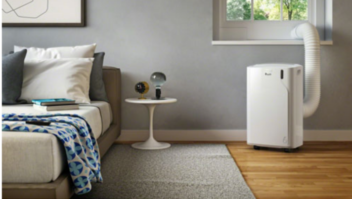 De'Longhi Pinguino portable air conditioner keeps a bedroom cool.