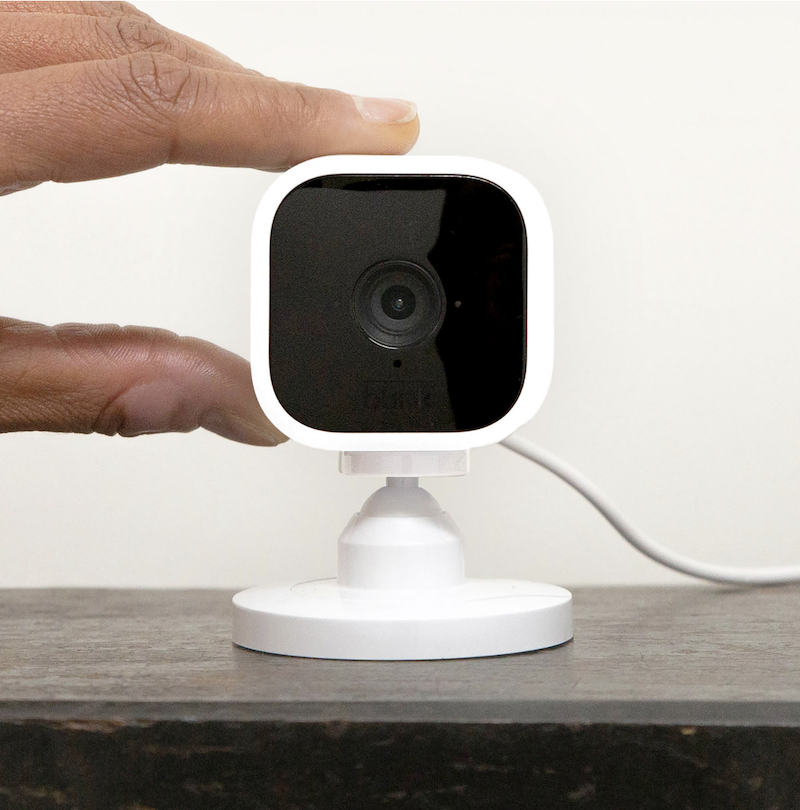 Blink mini Wi-Fi indoor camera with fingers to show scale.