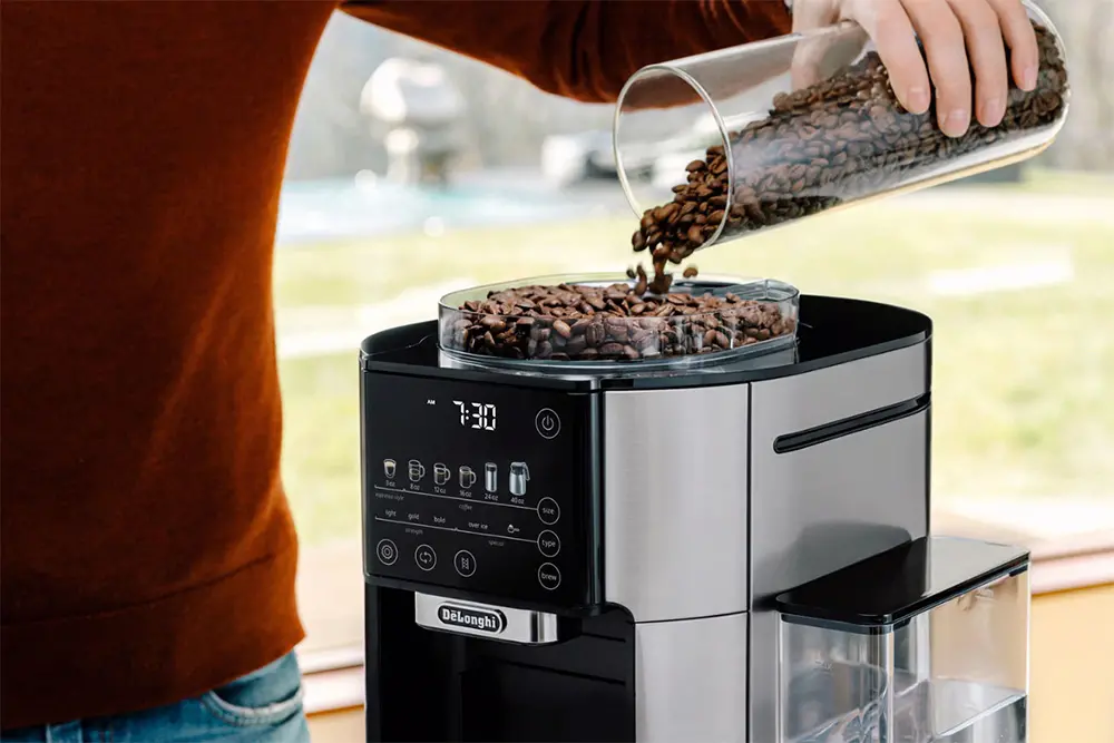 Man grinding coffee beans in espresso coffee machine.