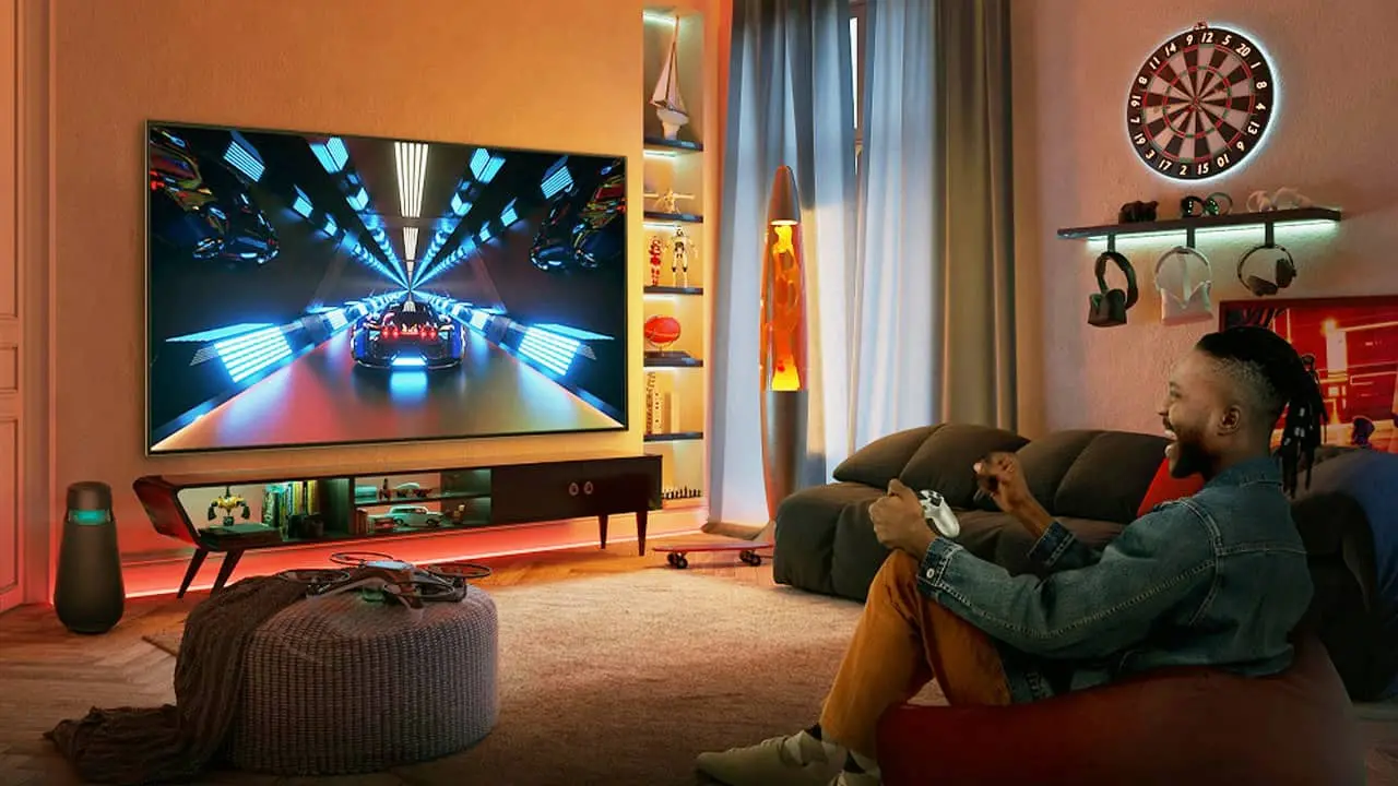 Man playing a Playstation on his Gaming TV displaying high refresh rates and Resolution