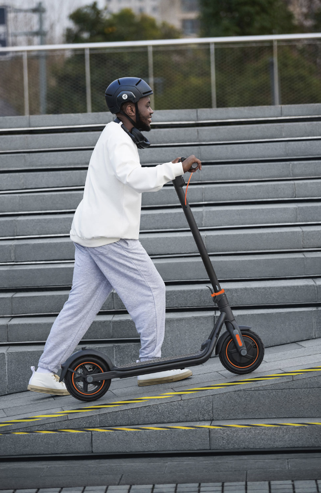 Man on a Segway Ninebot electric scooter.
