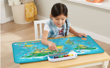 Young girl sitting on a chair and playing with the Leap Frog Touch and Learn World Map