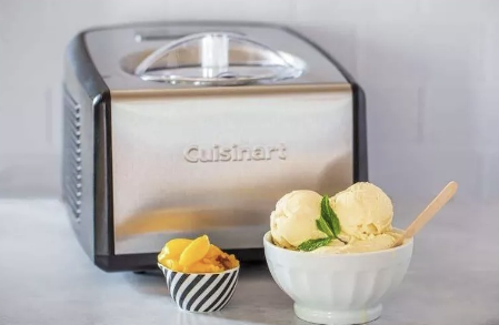 Cuisinart ice cream maker with ice cream in a bowl.