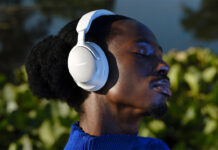 Man wearing Bose QuietComfort Ultra headphones in white.