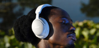 Man wearing Bose QuietComfort Ultra headphones in white.